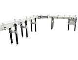Automatic variable speed power curve and custom chemical resistant conveyor, by Acasi Machinery Inc., left view.